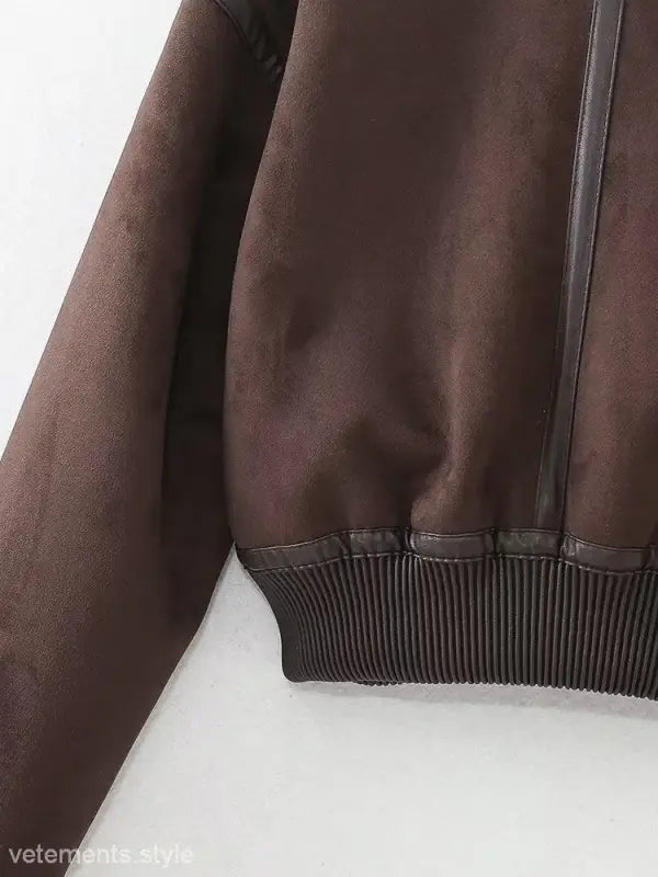 Brown leather bomber jacket with ribbed waistband, ideal as a faux shearling jacket for fall and winter wear
