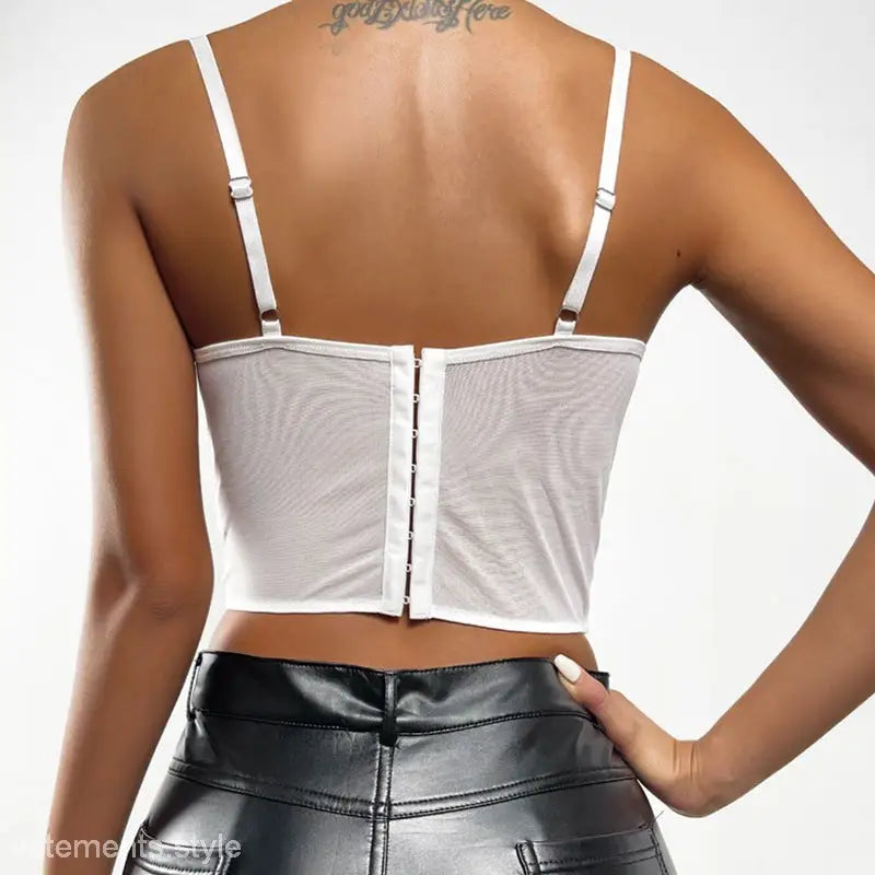 White mesh boning corset top with adjustable straps and hook closure, paired with black faux leather pants