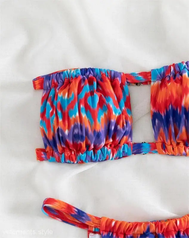 Colorful tie-dye patterned floral primary color printed bikini top with vibrant hues