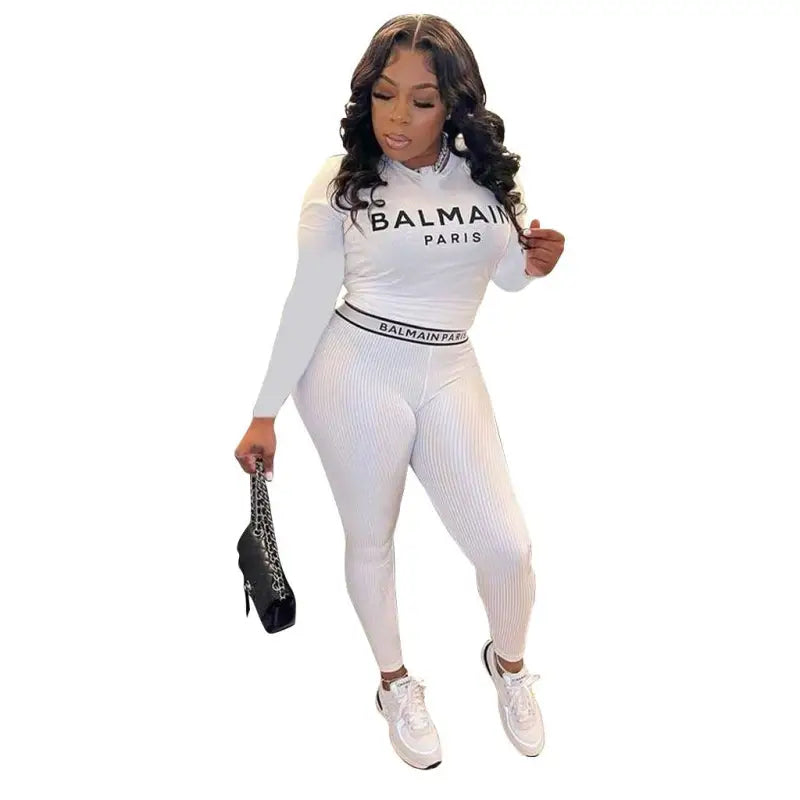 Woman in white Balmain pantsuit wearing a floral unique two piece set with slim long sleeves