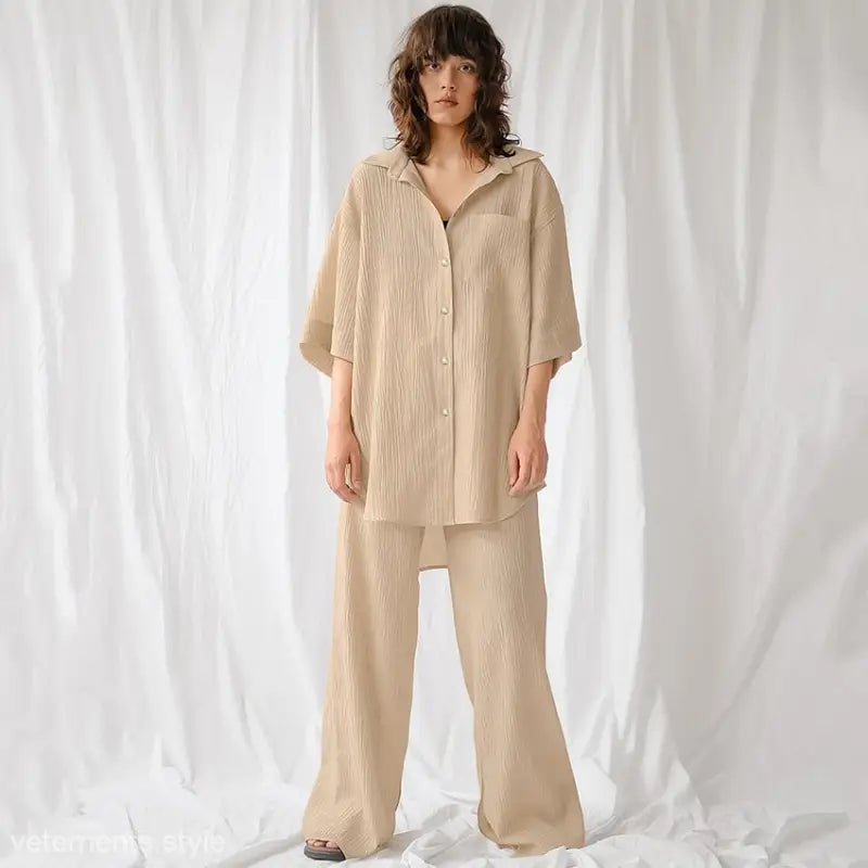 Woman wearing oversized beige shirt and wide-leg pants from French Cotton Comfortable Pajamas Set for spring lounging