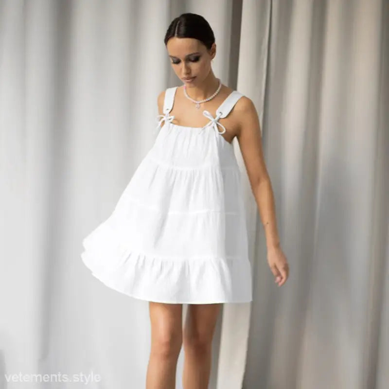 White sleeveless sundress with tie straps, flowy silhouette, perfect as a French nightdress pajamas