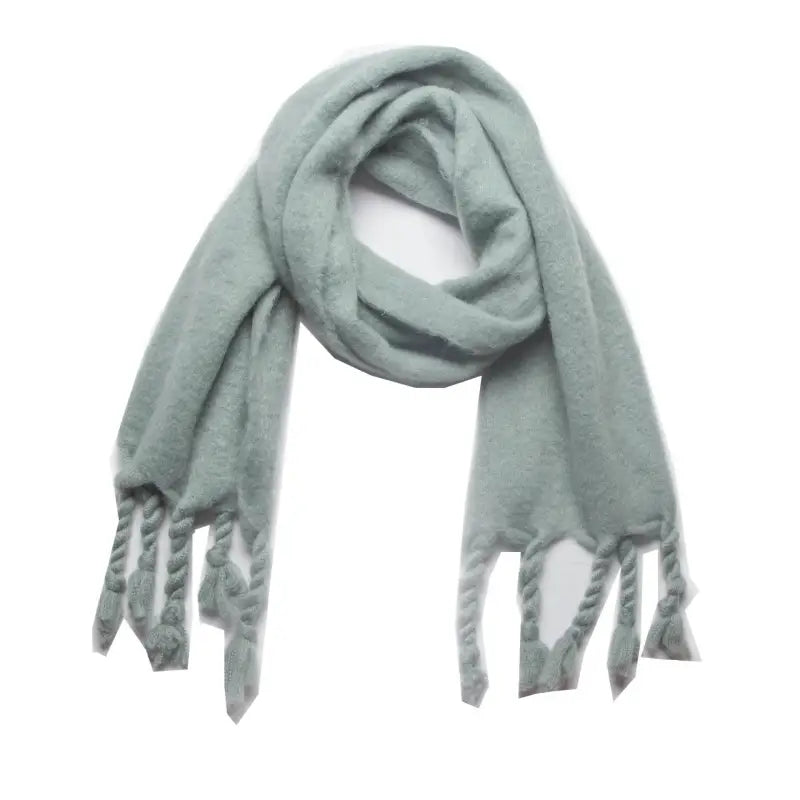 Light blue fuzzy wool scarf with tassels, perfect for winter wear as a stylish shawl