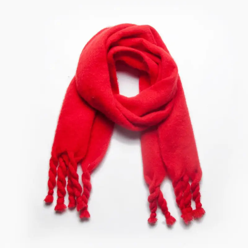 Red wool scarf with braided tassels, perfect for winter wear and stylish shawl options