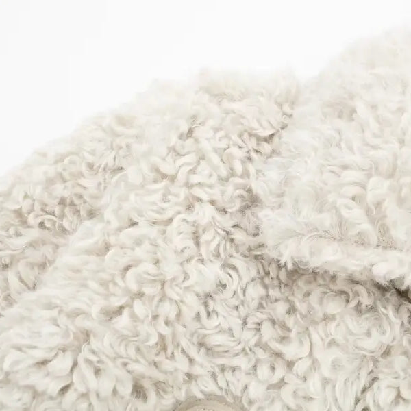 Textured off-white faux fur garment showcased as a winter furry short jacket