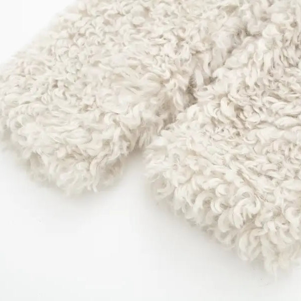 Fluffy light-colored fabric of a winter furry short jacket for casual nights out