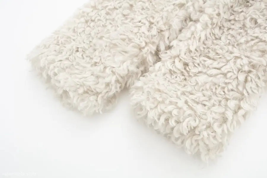 Fluffy light-colored fabric of a winter furry short jacket for casual nights out
