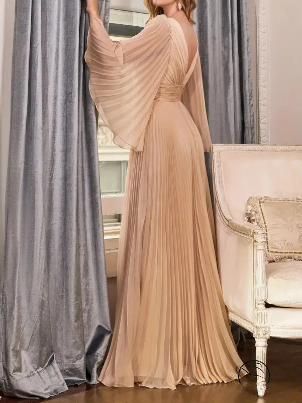 Gorgeous evening dress with elegant pleated gown and flowing trumpet sleeves
