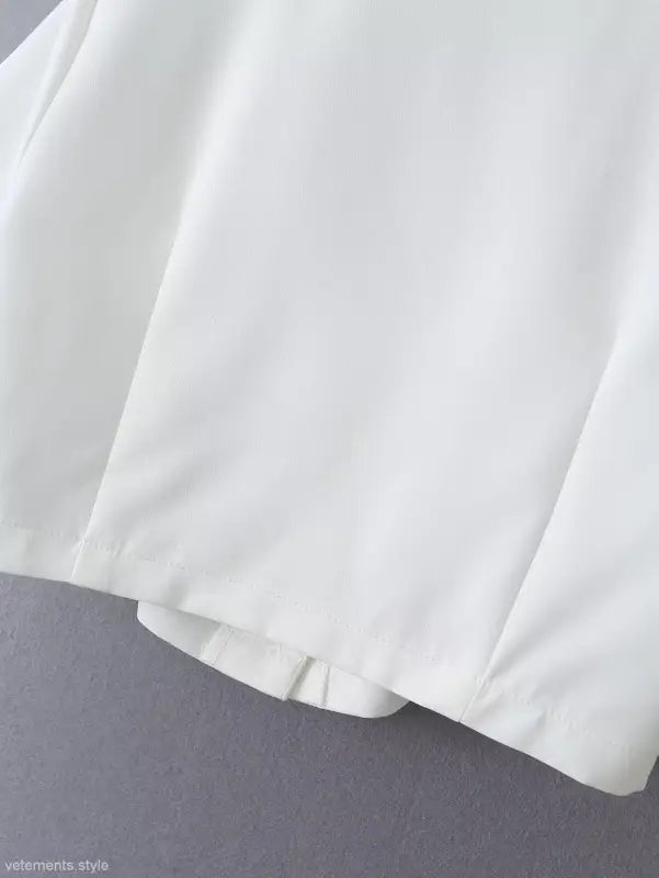 White fabric garment from Gorgeous Yacht Fit Crop Top with Button and Pocket Detail