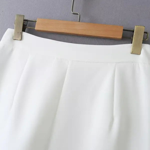 White pleated skirt on hanger complements gorgeous yacht fit and high waist style