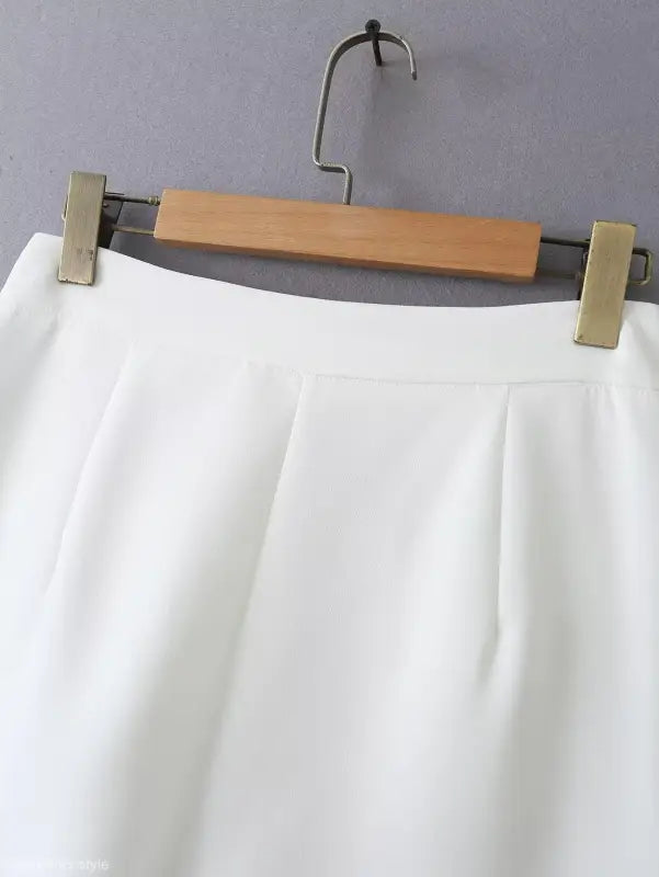White pleated skirt on hanger complements gorgeous yacht fit and high waist style