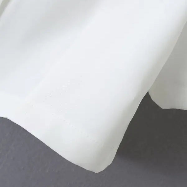 White blazer sleeve detail from Gorgeous Yacht Fit crop top with high waist and button design