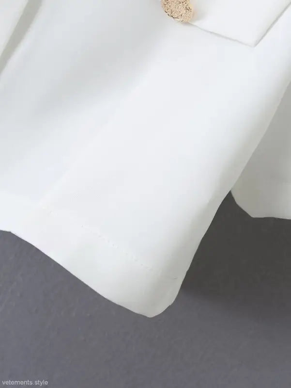 White blazer sleeve detail from Gorgeous Yacht Fit crop top with high waist and button design