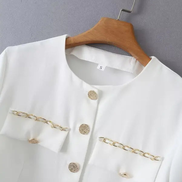 White jacket with gold chain detail from Gorgeous Yacht Fit crop top collection featuring high waist design