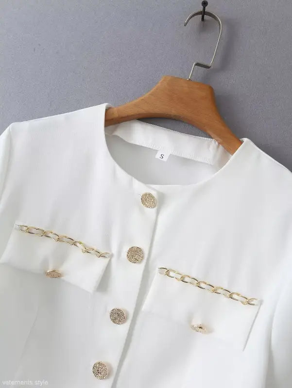 White jacket with gold chain detail from Gorgeous Yacht Fit crop top collection featuring high waist design