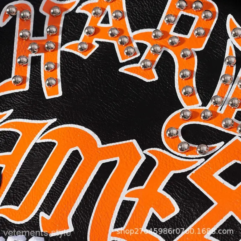 Black leather jacket with orange studded lettering, graffiti printing motorcycle style