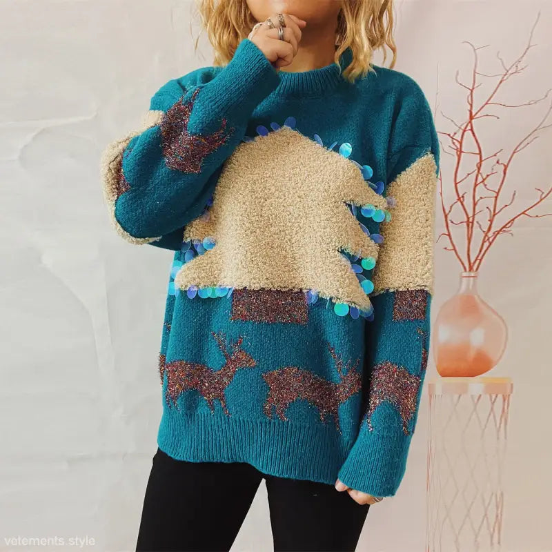 Teal handmade Christmas sweater with beige and brown patterns and blue pom-poms