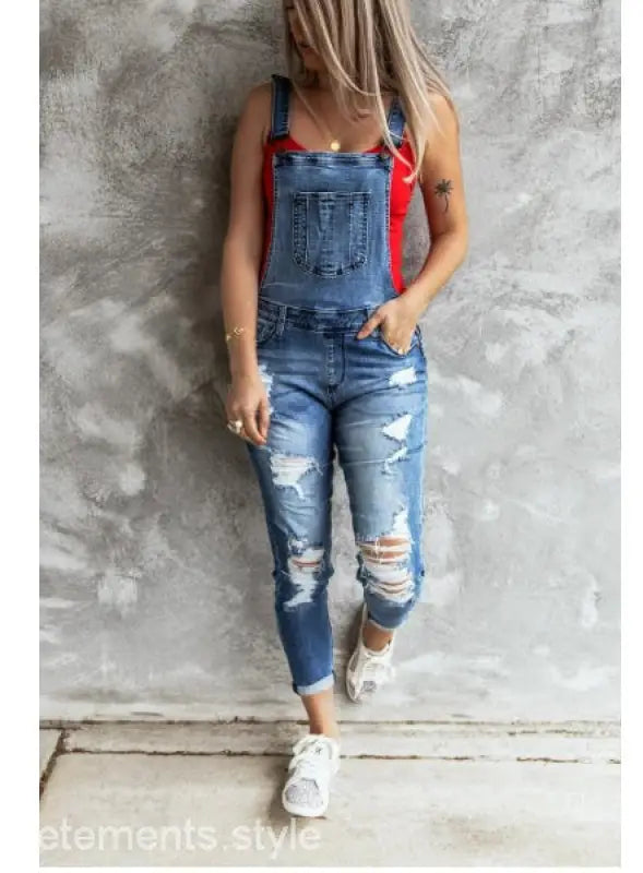 Women wearing Hanna Stretch Denim high rise overall trousers with a red tank top and white sandals