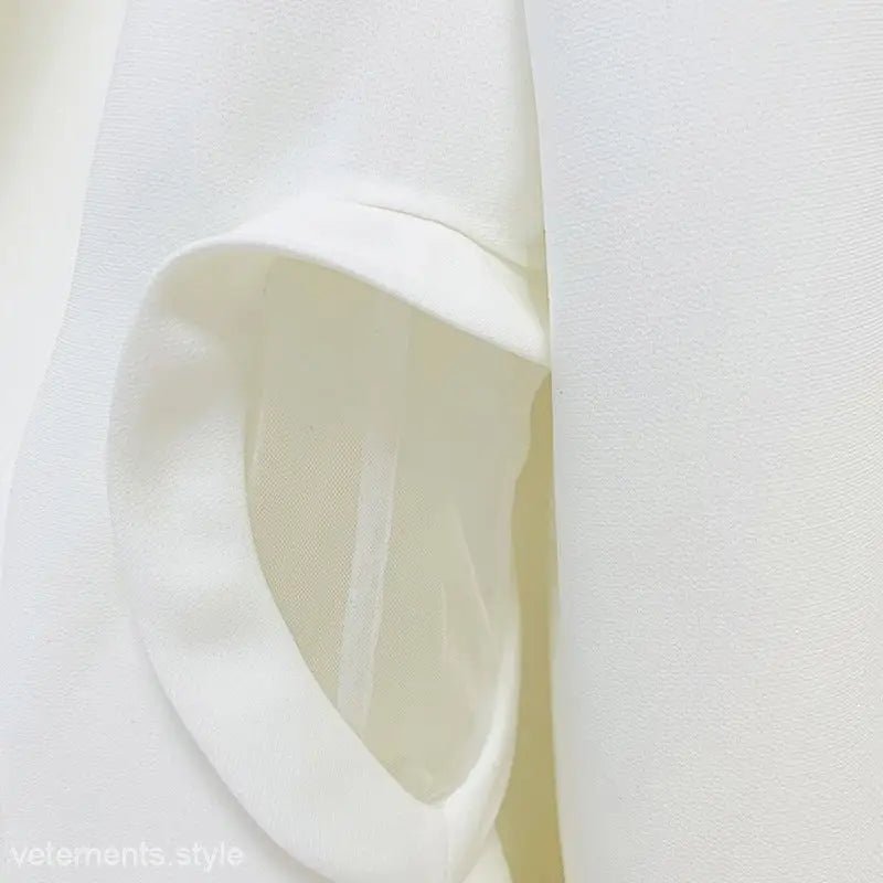 White cloth napkin folded into a decorative shape for the Heart Shaped Slim Fit Elegant Long Sleeve Office Top