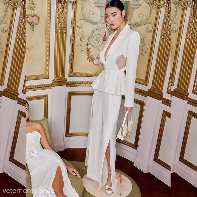 Elegant woman in white peplum suit with side cutouts, holding a small handbag