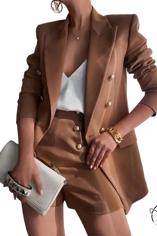 Brown tailored suit ensemble with white camisole and clutch, showcasing a high end jacket