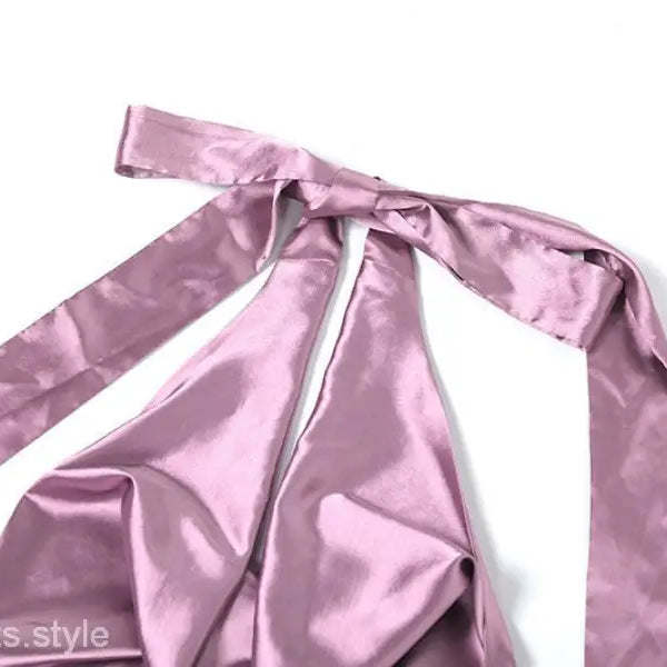 Pink satin ribbon or fabric tie with long trailing ends on high grade halter dress