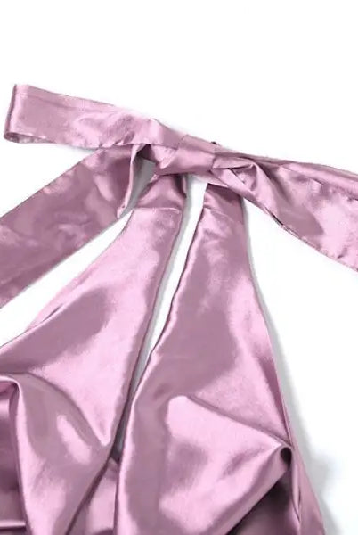 Pink satin ribbon or fabric tie with long trailing ends on high grade halter dress