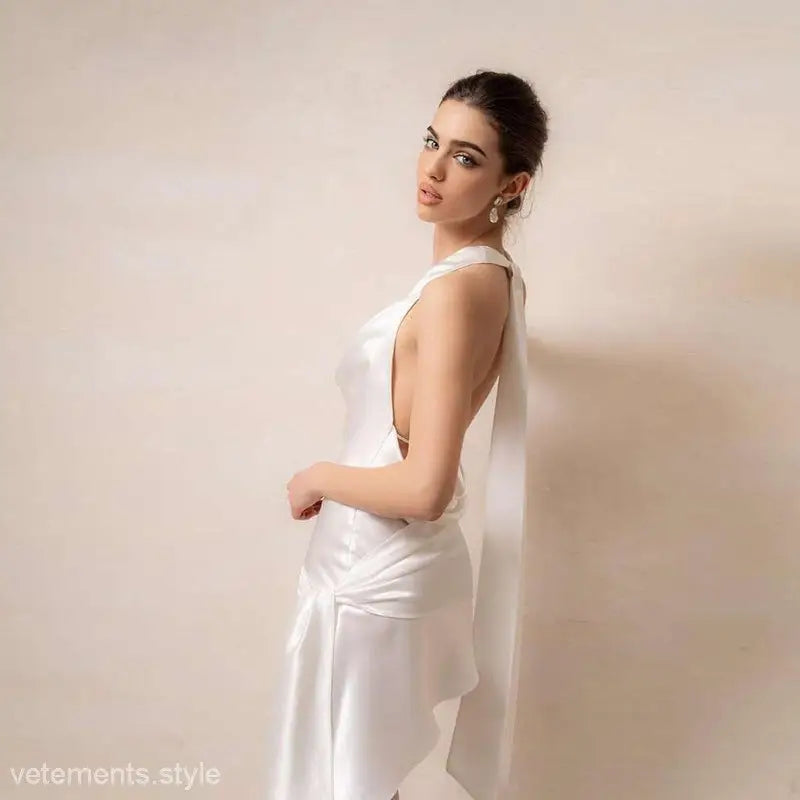 Elegant woman wearing a high grade halter dress with asymmetric backless design