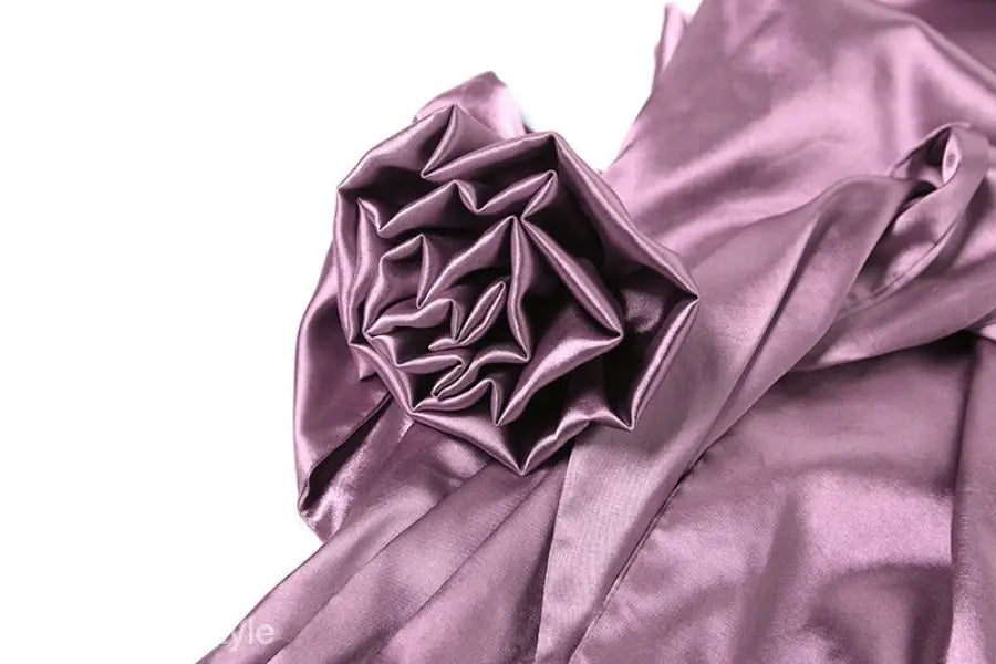 Shimmering purple silk fabric with intricate folds on a high grade halter dress