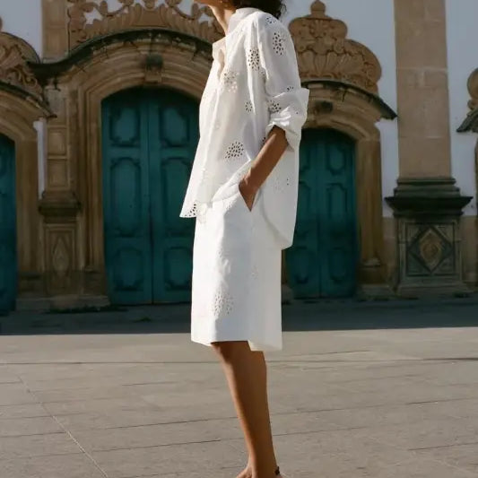 Woman in elegant white eyelet dress with sandals, showcasing high waist casual hollow style