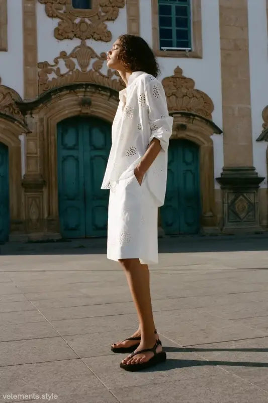 Woman in elegant white eyelet dress with sandals, showcasing high waist casual hollow style
