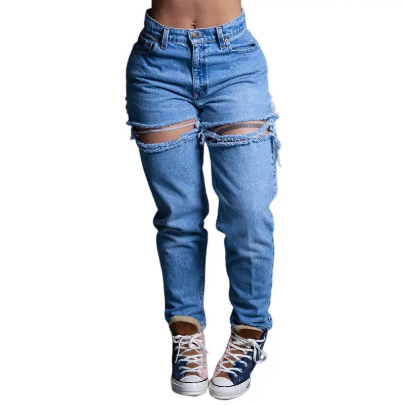 High waist loose jeans with rips at thighs paired with high-top sneakers