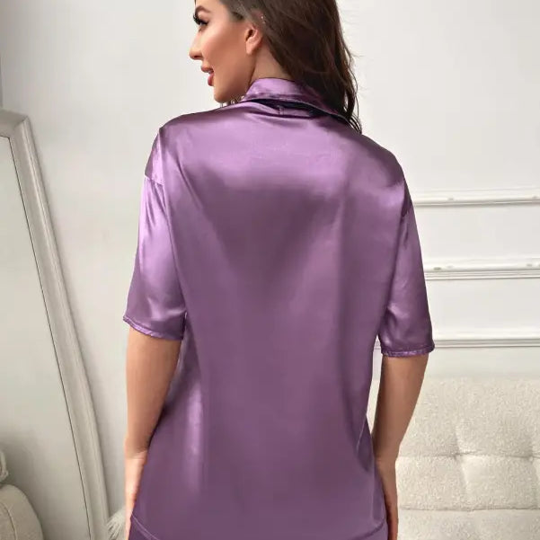 Purple satin pajama set featuring a short sleeve top with pockets in imitated silk fabric