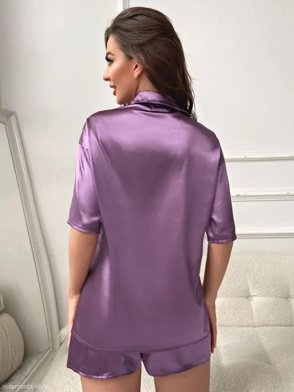 Purple satin pajama set featuring a short sleeve top with pockets in imitated silk fabric