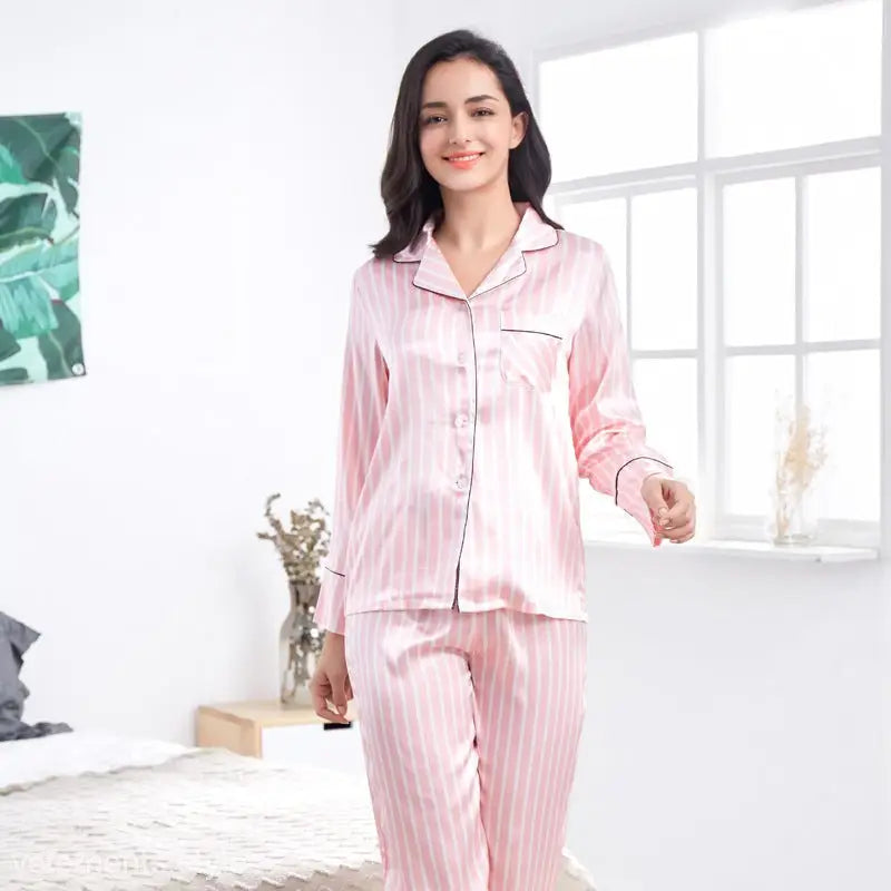Pink and white imitated silk striped lounge set worn by woman in bright home interior