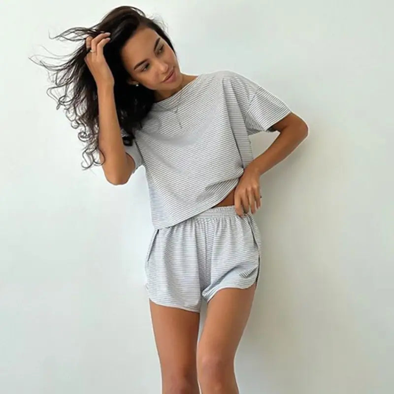 Woman wearing light gray and white striped knitted loose pajamas summer lounge set