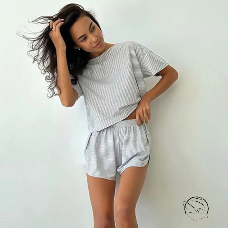 Woman in knitted loose pajamas: gray white striped crop top and shorts
