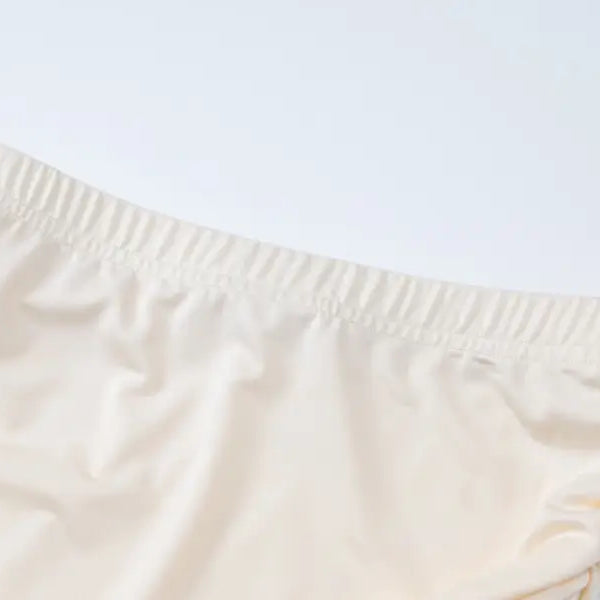 Cream-colored elastic waistband shorts from the Lace Vest Pleated Skirt Set for summer style