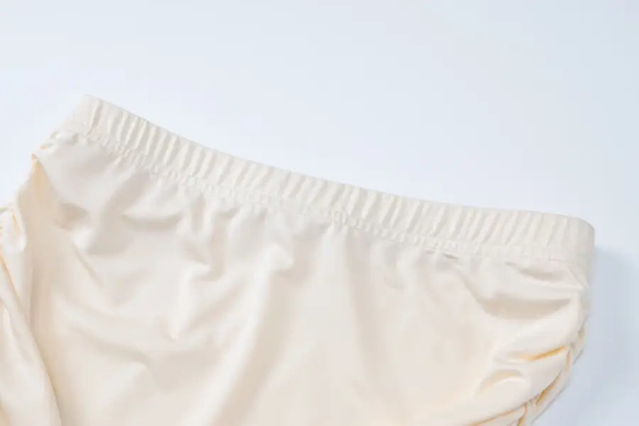 Cream-colored elastic waistband shorts from the Lace Vest Pleated Skirt Set for summer style