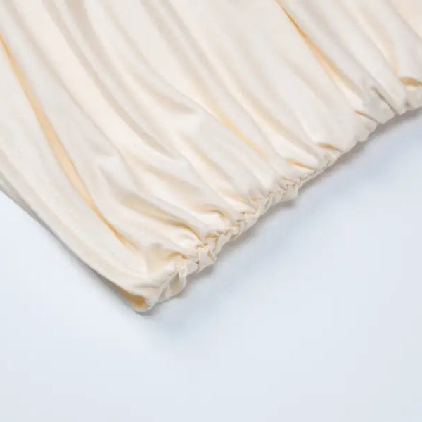 Wrinkled elasticized cream-colored fabric for lace vest pleated skirt set in stylish summer look