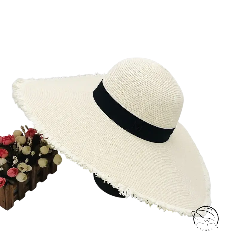 Lack of Color wide-brim sun hat in off-white straw with black ribbon band