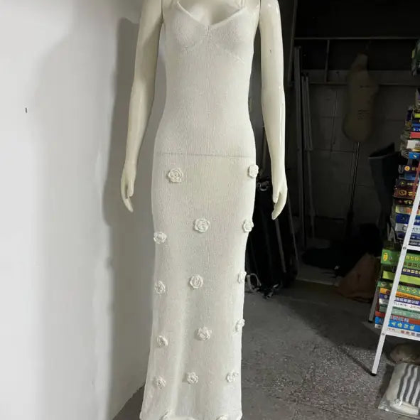 White floral-embellished backless bodycon maxi dress displayed on a mannequin