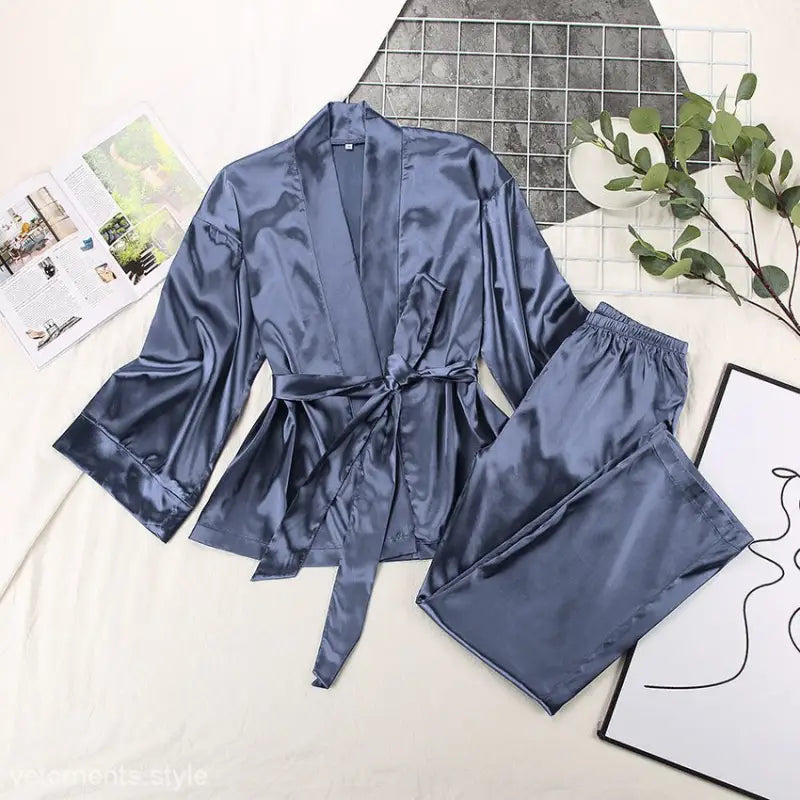 Silky blue-gray satin pajamas set with robe-style top and matching pants for casual comfort
