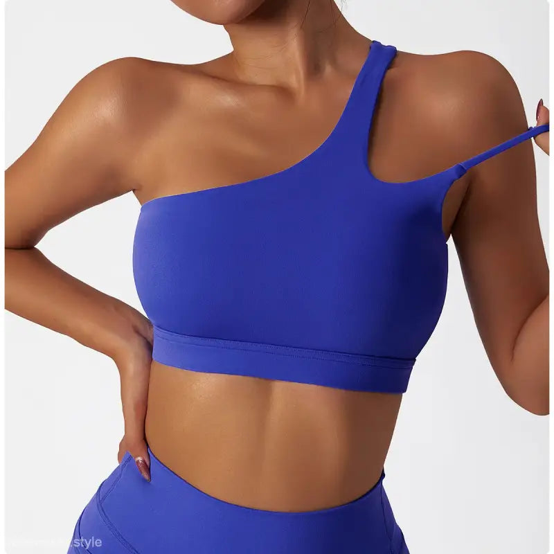 Light gray blue one-shoulder sports bra featuring a stylish cutout back design