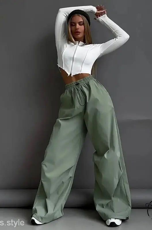 Woman in white crop top and light gray casual cute trousers
