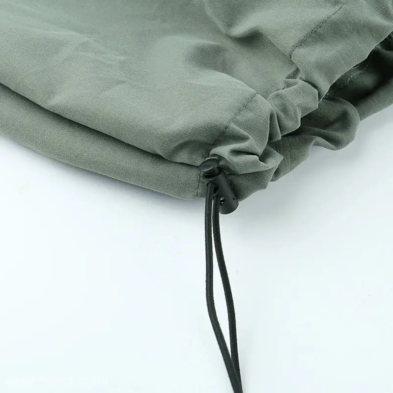 Drawstring closure on olive green fabric of casual cute trousers with light gray style