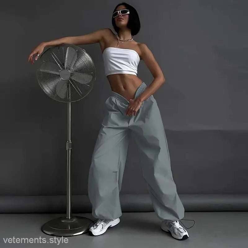 Woman in white tube top and baggy light gray casual cute trousers displayed