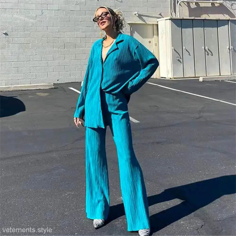 Turquoise pleated pantsuit displayed with versatile casual style and textured fabric