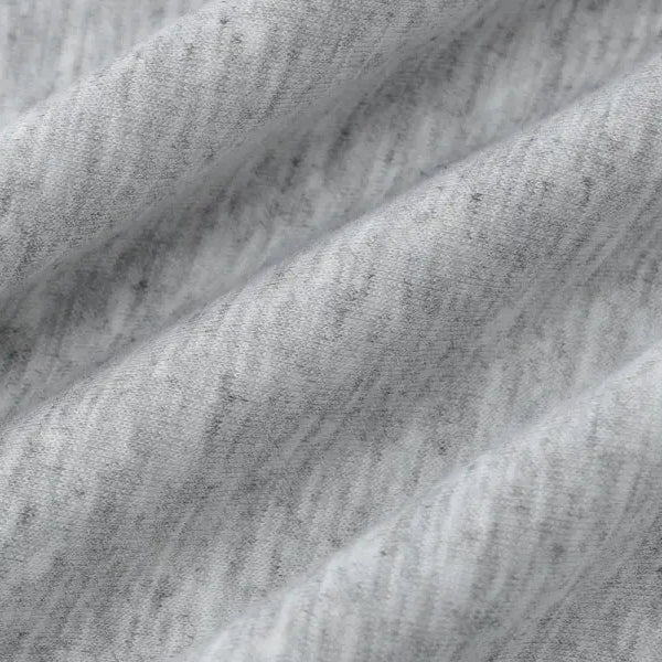 Textured gray fabric with diagonal folds or creases.