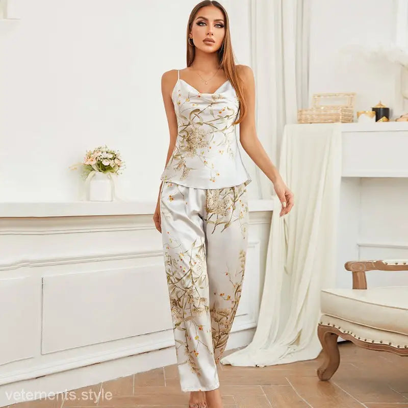 Woman in white satin ice silk pajamas set with floral print, featuring light green cherry design